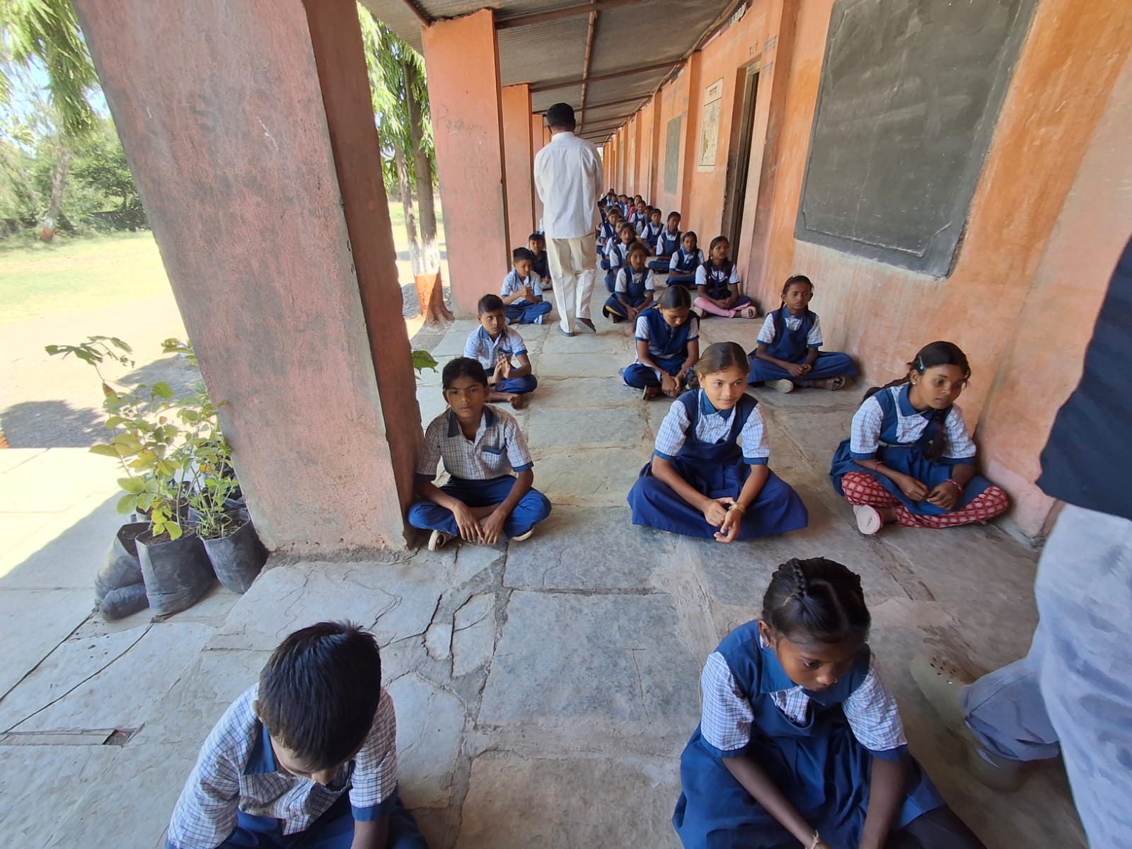 Students seated on a rural school veranda